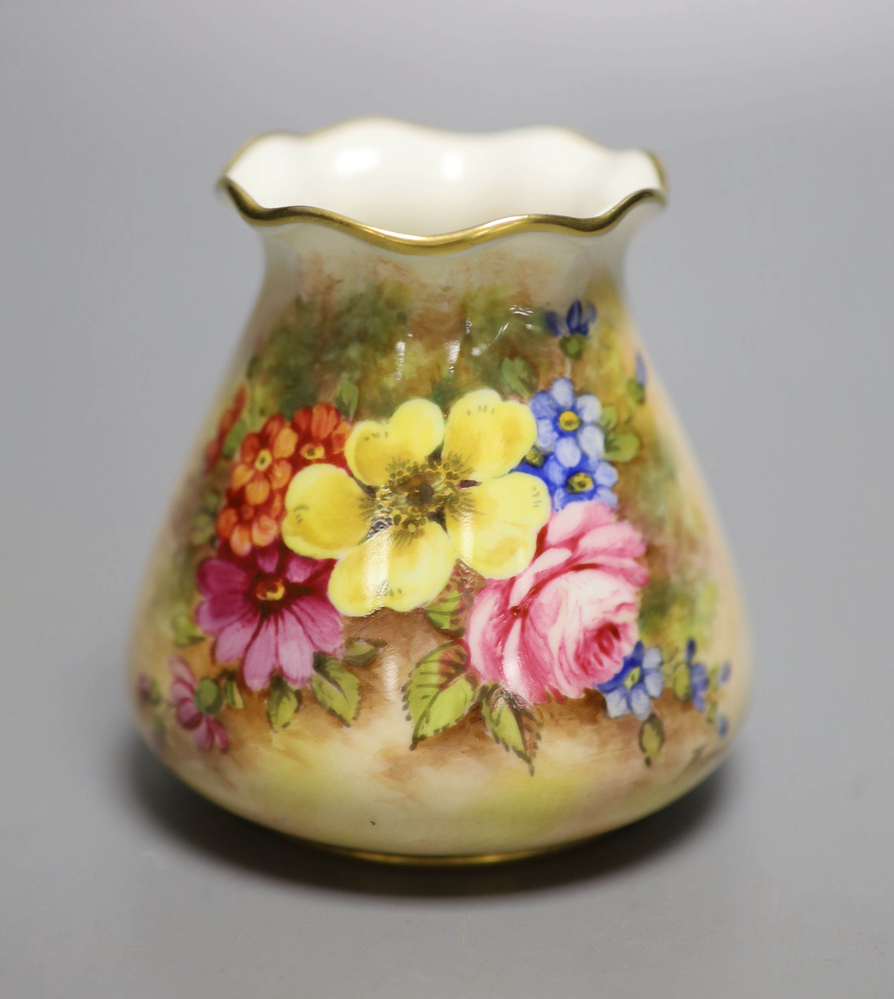 A Royal Worcester sack shape vase, with pie crust rim, painted with a fine floral study by J Freeman, signed, black date mark 1952